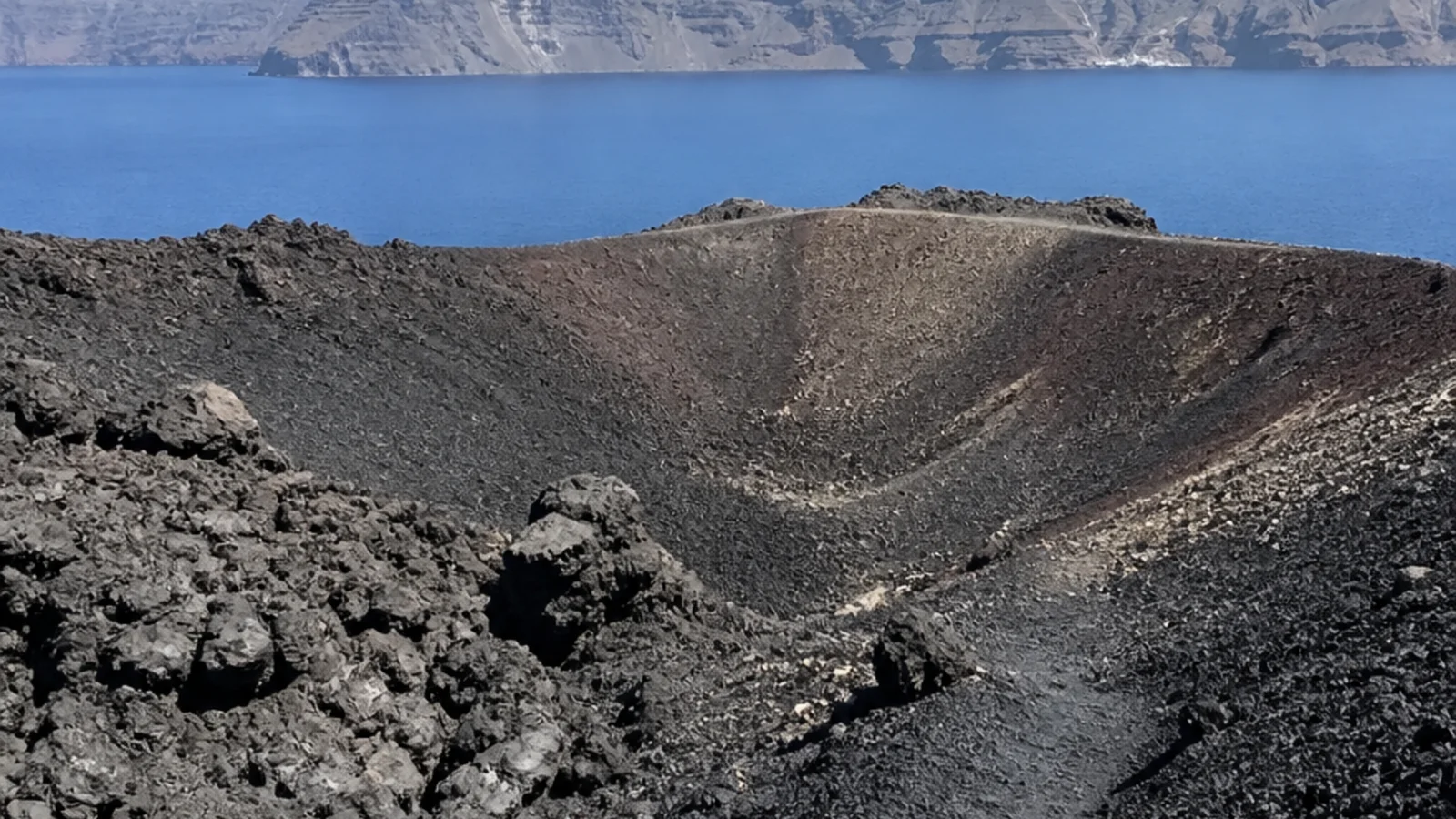 Black volcanic landscape of Nea Kameni inside the Santorini Caldera